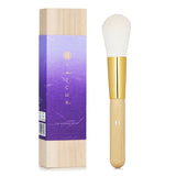 Elegant Tatcha Powder Brush with synthetic bristles for flawless makeup application, featuring a gold ferrule and wood handle.