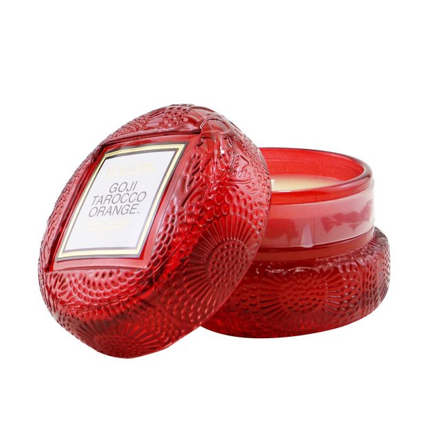 Elegant Voluspa Macaron Candle in Goji Tarocco Orange, showcasing a textured glass container and eco-friendly coconut wax blend.