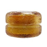 Elegant Voluspa Macaron Candle in Baltic Amber, 5.1g, with geometric glass design and eco-friendly coconut wax blend.