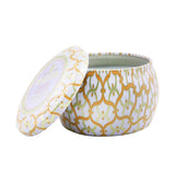 Voluspa Mini Tin Candle in Italian Bellini, 4oz, features a peach-prosecco scent in a decorative tin, perfect for ambiance.