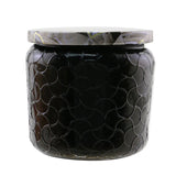 Voluspa Petite Jar Candle Ambre Lumiere in an embossed glass jar, offering a soothing fragrance and 35-hour burn time.