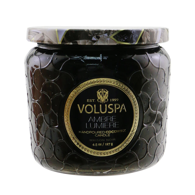 Voluspa Petite Jar Candle in Ambre Lumiere, 127g, in an embossed glass container with enchanting, long-lasting fragrance.