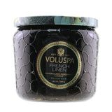 Voluspa Petite Jar Candle in French Linen offers a soothing scent, housed in an elegant embossed glass jar with a clean burn formula.