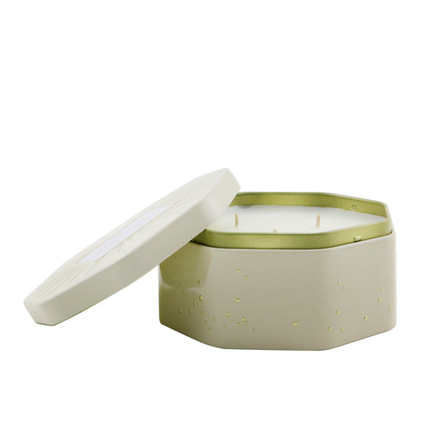 Elegant Voluspa candle in an octagonal tin, featuring Coconut Papaya scent, three wicks, and a gold interior for ambiance.