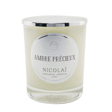 Luxurious Nicolai Ambre Précieux scented candle in elegant glass, offering a comforting fragrance and 50-hour burn time.