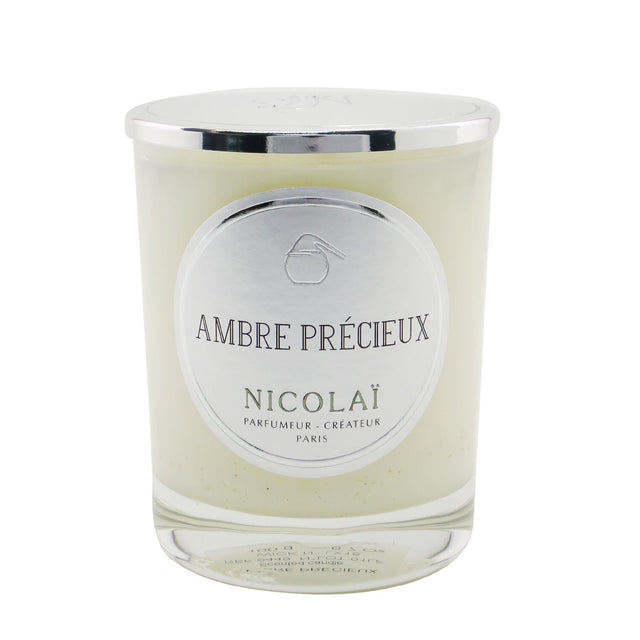 Luxurious Nicolai Ambre Précieux scented candle in elegant glass, offering a comforting fragrance and 50-hour burn time.