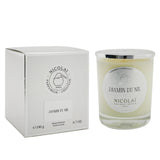 Luxurious Nicolai Jasmin Du Nil scented candle in a decorative glass container, offers a calming jasmine aroma for up to 50 hours.