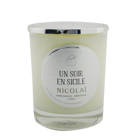 Elegant Nicolai scented candle in a glass container, offering a comforting fragrance inspired by serene Sicilian evenings.