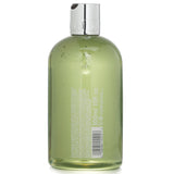 Molton Brown Lily & Magnolia Blossom Bath & Shower Gel, 300ml, vegan formula with floral scent for gentle, effective skin cleansing.