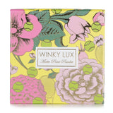 Transparent setting powder from Winky Lux, ideal for all skin tones; absorbs oil, blurs pores, and locks in makeup for all-day wear.