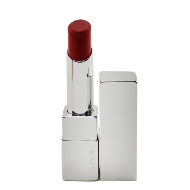 Luxurious RMK #12 Candy Apple lipstick offering long-lasting shine, comfort, and hydration with a delightful fig scent.