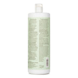 Paul Mitchell Clean Beauty Anti-Frizz Shampoo, 1000ml, hydrates and smooths frizz-prone hair with organic ingredients and floral scent.