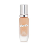 La Mer Soft Fluid Long Wear Foundation SPF 20 in #140 Alabaster, 30ml, offers lightweight coverage and UV protection.