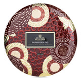 "Voluspa Forbidden Fig candle in decorative tin, featuring a rich fig fragrance, three wicks, and a luxurious design."
