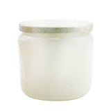 A luxurious mini candle in a decorative glass jar, featuring the soothing scents of eucalyptus and white sage.