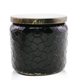 Voluspa Burning Woods candle: Mini jar in an elegant glass, coconut wax, natural wicks, warm forest scent, 35-hour burn time.
