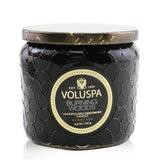 A petite jar candle with a luxurious coconut wax blend, featuring the warm scent of Burning Woods and an elegant glass container.