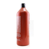 Salón size Redken Frizz Dismiss Conditioner, 1000ml, tames frizz with Babassu oil for smooth, shiny hair.