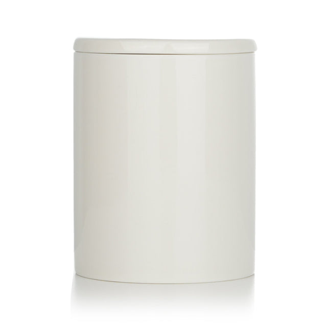 Eco-friendly Bjork & Berries Midvinternatt candle in decorative container, scented with green fir, cedarwood, and eucalyptus.