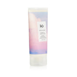 Creamy R+Co On a Cloud Baobab Oil Repair Masque for damaged hair, enriched with nourishing oils for strength and shine.