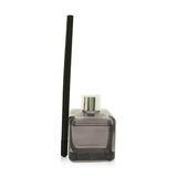 Elegant lilac glass cube scented bouquet with silver ring and polymer twigs, neutralizes laundry odors with floral fragrance.