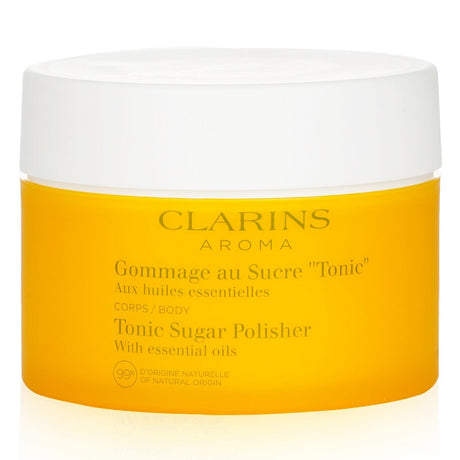 Clarins Tonic Sugar Polisher, a 250g body scrub with essential oils, nourishes, exfoliates, and revitalizes all skin types.