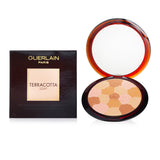 Guerlain Terracotta bronzer #00 Light Cool, a lightweight powder for a sun-kissed glow, enriched with Moroccan honey for hydration.