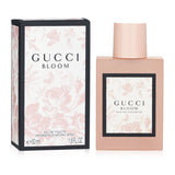 Gucci Bloom Eau De Toilette Spray in a frosted pink bottle, featuring floral notes for a radiant and uplifting scent.