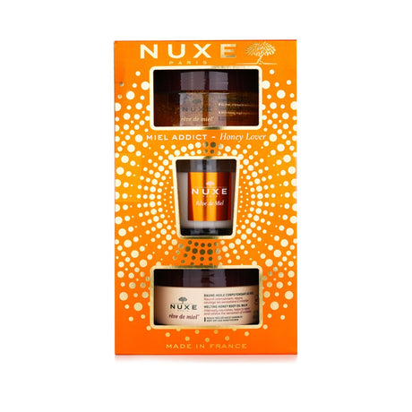 Nuxe Honey Lover Set: 3-piece skincare set with body scrub, oil balm, and candle for silky, nourished skin.
