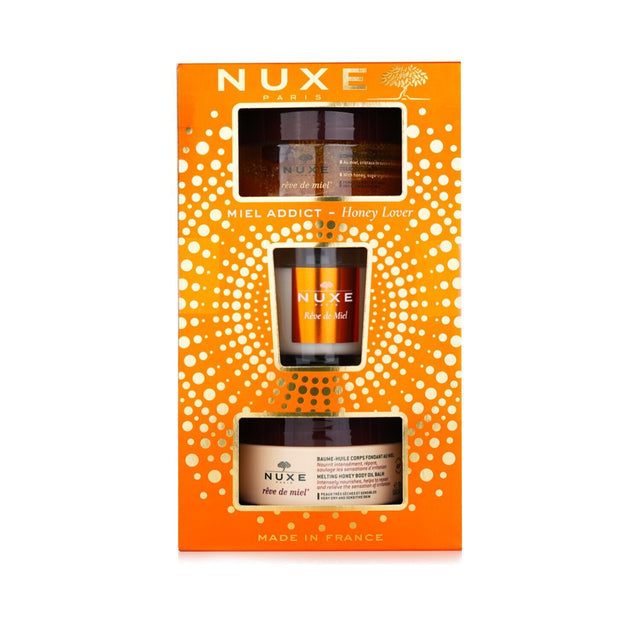 Nuxe Honey Lover Set: 3-piece skincare set with body scrub, oil balm, and candle for silky, nourished skin.