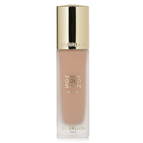 Guerlain Parure Gold Skin Matte Foundation SPF15 #1C Cool in frosted glass, offers luxurious matte finish with UV protection.