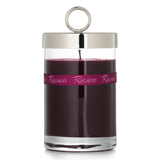 Rigaud Bois Precieux scented candle in a glass container with bow, offers exotic woody aroma and 90-hour burn time.