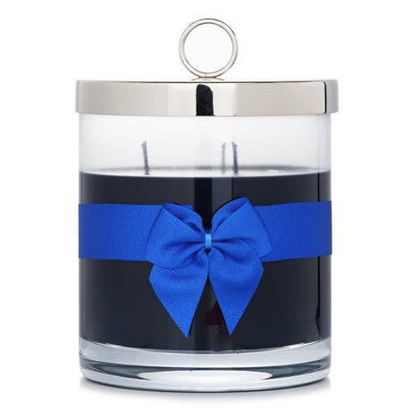 Luxurious Rigaud scented candle in glass, inspired by the night sky, with 150-hour burn time and elegant bow tie detail.