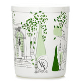 Scented candle in geometric white glass, infused with green and floral notes, evoking a serene French garden ambiance.