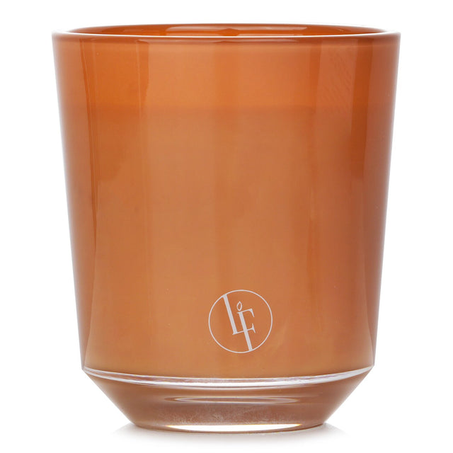 Elegant 200g vanilla-scented candle in a glass container, blending sweet vanilla, orange, and jasmine for a cozy ambiance.