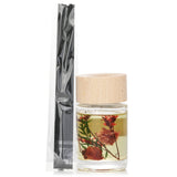 Botanica wood mist reed diffuser in rose, 60ml, with transparent bottle and wooden lid, emits inviting floral scent.