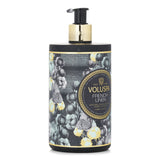 Luxurious 450ml Voluspa hand lotion with Coconut Water, soothing scent of Cotton Flower, in an elegant frosted bottle.