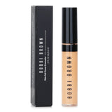 Featherweight Bobbi Brown Skin Full Cover Concealer in Warm Beige, providing seamless coverage for dark circles and blemishes.