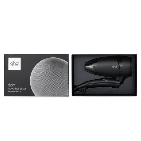 Compact black travel hair dryer by GHD, featuring dual voltage, foldable design, and fast drying for salon-quality results.