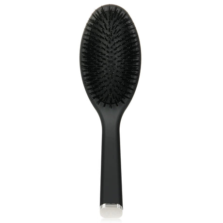 GHD Oval Dressing Brush in black, designed for mid to long hair, features anti-static nylon bristles for detangling and shine.