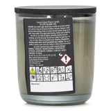 Natural wax candle in a glass jar, exuding a floral scent of lavender and citrus, perfect for creating a soothing atmosphere.
