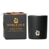 Noble Isle Whisky & Water Candle in a elegant jar, offering rich whisky and oak fragrance for a cozy home atmosphere.
