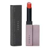 THREE Arising Spirit Lip Glow #04 Dancer Awakens offers vivid color and hydration, melting onto lips for a radiant finish.