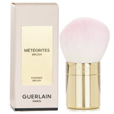 Guerlain Meteorites Powder Brush with soft synthetic bristles and golden handle, perfect for seamless makeup application.