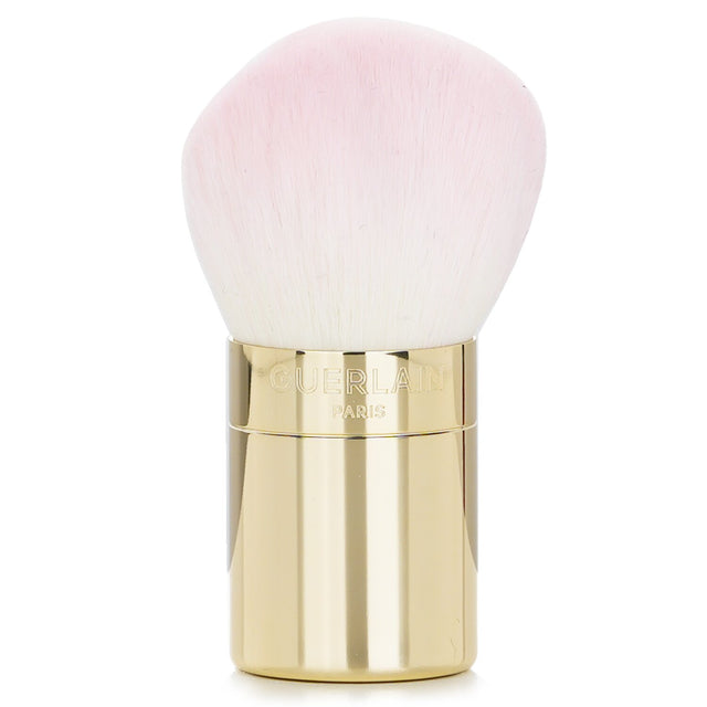 Guerlain Meteorites Powder Brush with soft synthetic bristles and golden handle for seamless powder application.