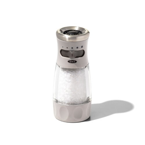 Sleek OXO salt grinder with adjustable coarseness, airtight lid, and non-slip grip for mess-free seasoning.