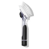 OXO Good Grips Soap Dispensing Dish Brush with ergonomic handle, soap reservoir, durable bristles, and built-in scraper for easy cleaning.