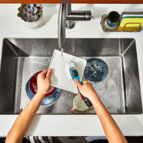 Innovative soap dispensing dish brush with ergonomic grip, durable bristles, and built-in scraper for easy cleaning.