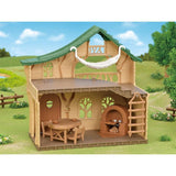 A cozy Sylvanian Families Lakeside Lodge with furniture, cooking accessories, and a secret slide for baby figures.