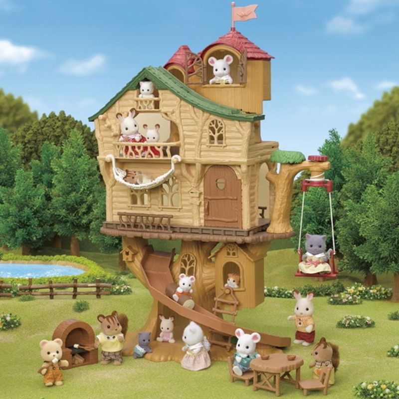 Sylvanian Families Lakeside Lodge with furniture, hammock, and secret slide, perfect for imaginative play.